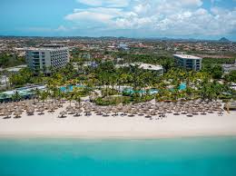 Hilton Aruba Caribbean Resort and Casino on Palm Beach with high-rise towers, beachfront pools, casino, and family-friendly amenities.