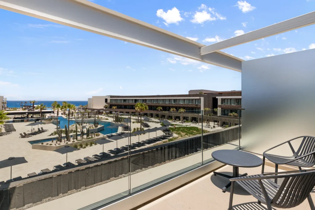 Junior Suite Ocean View private balcony overlooking the pool and Caribbean Sea at Secrets Baby Beach Aruba.