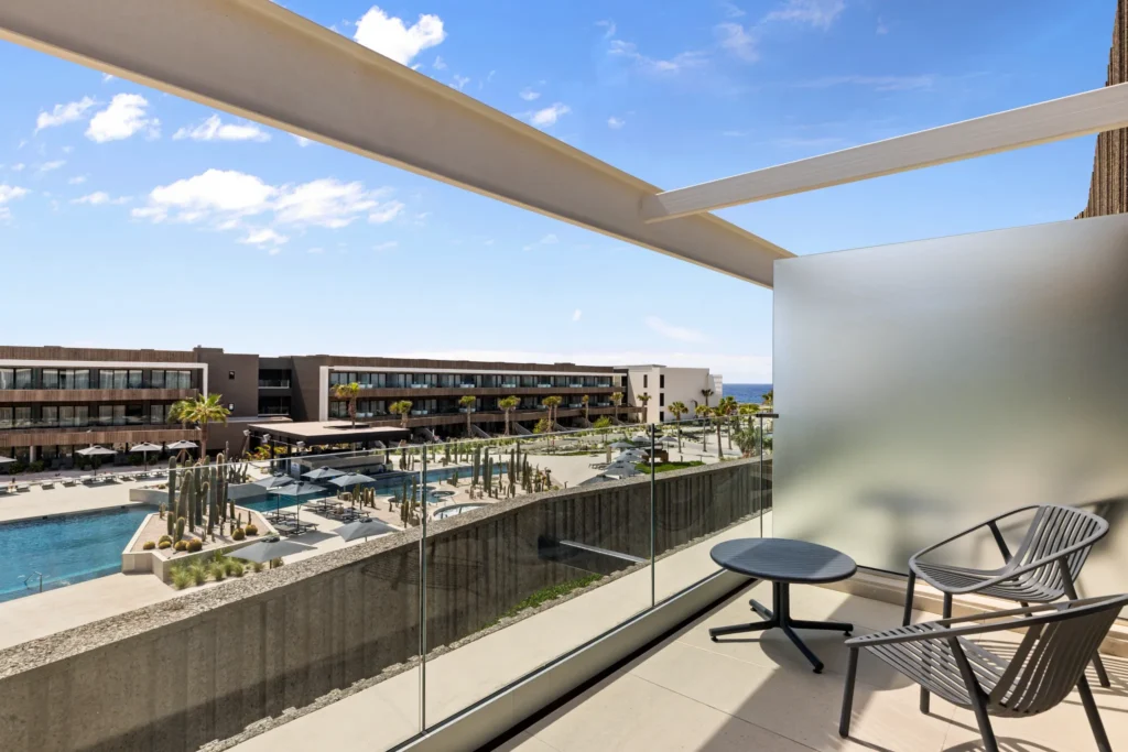 Private furnished balcony with pool view at Junior Suite Pool View in Secrets Baby Beach Aruba.