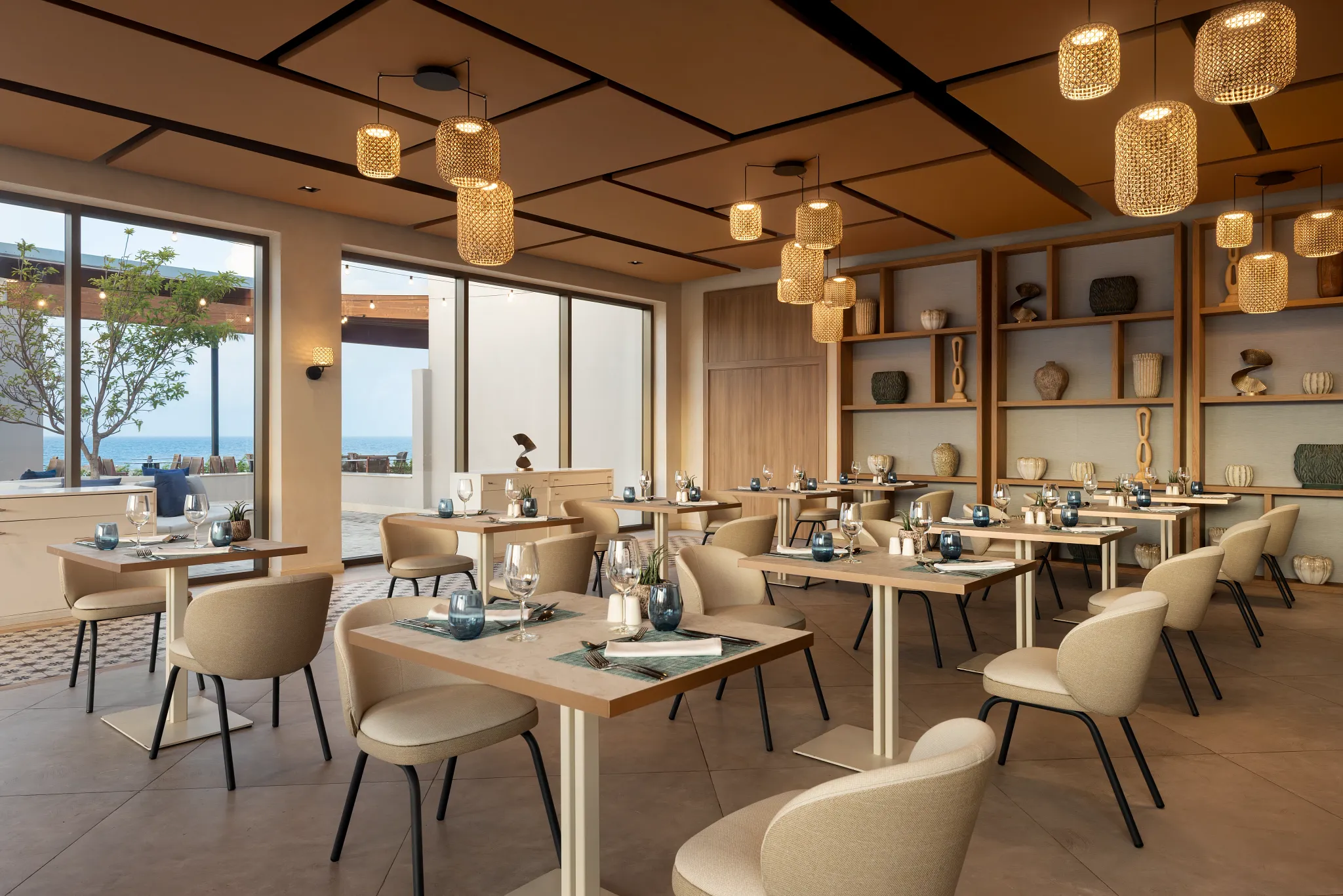 Oceana seafood restaurant at Secrets Baby Beach Aruba featuring elegant dining tables, warm lighting, and ocean-view ambiance.
