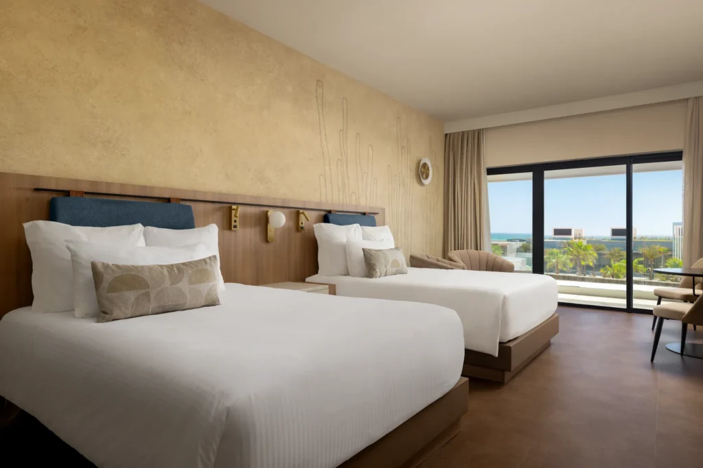 Preferred Club Junior Suite with two double beds and private balcony at Secrets Baby Beach Aruba.