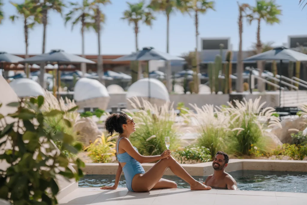 Couple relaxing with champagne in a private swim-out pool at Secrets Baby Beach Aruba.