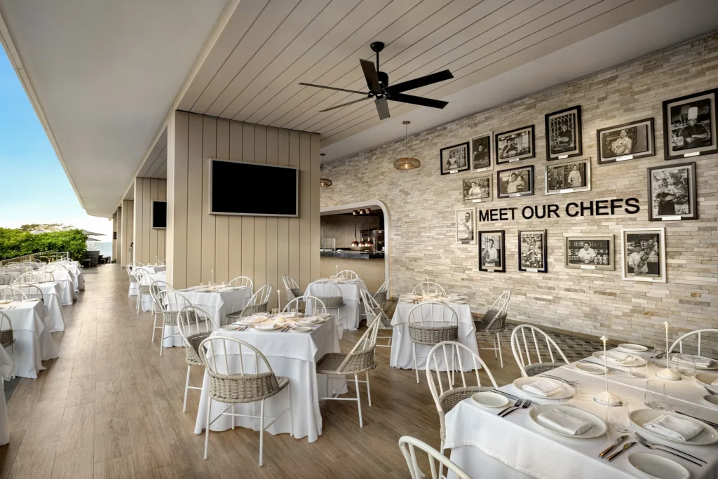 Bluewater Grill Beach Club at Secrets Bahia Mita Surf & Spa Resort featuring an open-air dining space with ocean views, white table settings, and casual elegant ambiance.