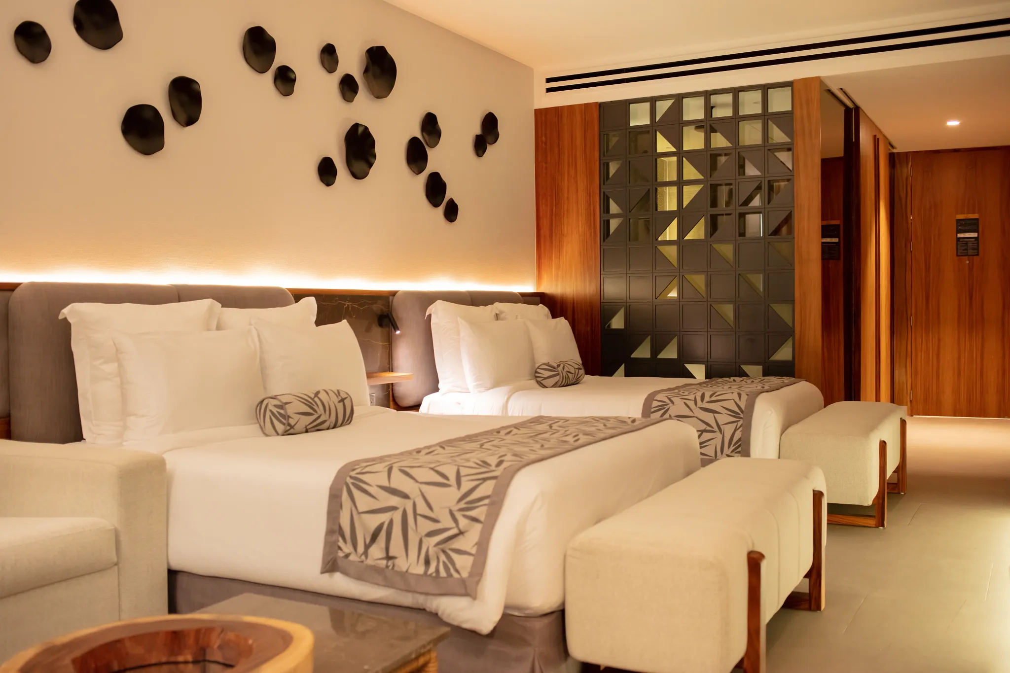 Junior Suite Panoramic View with two queen beds and modern décor at Secrets Bahia Mita Surf & Spa Resort.