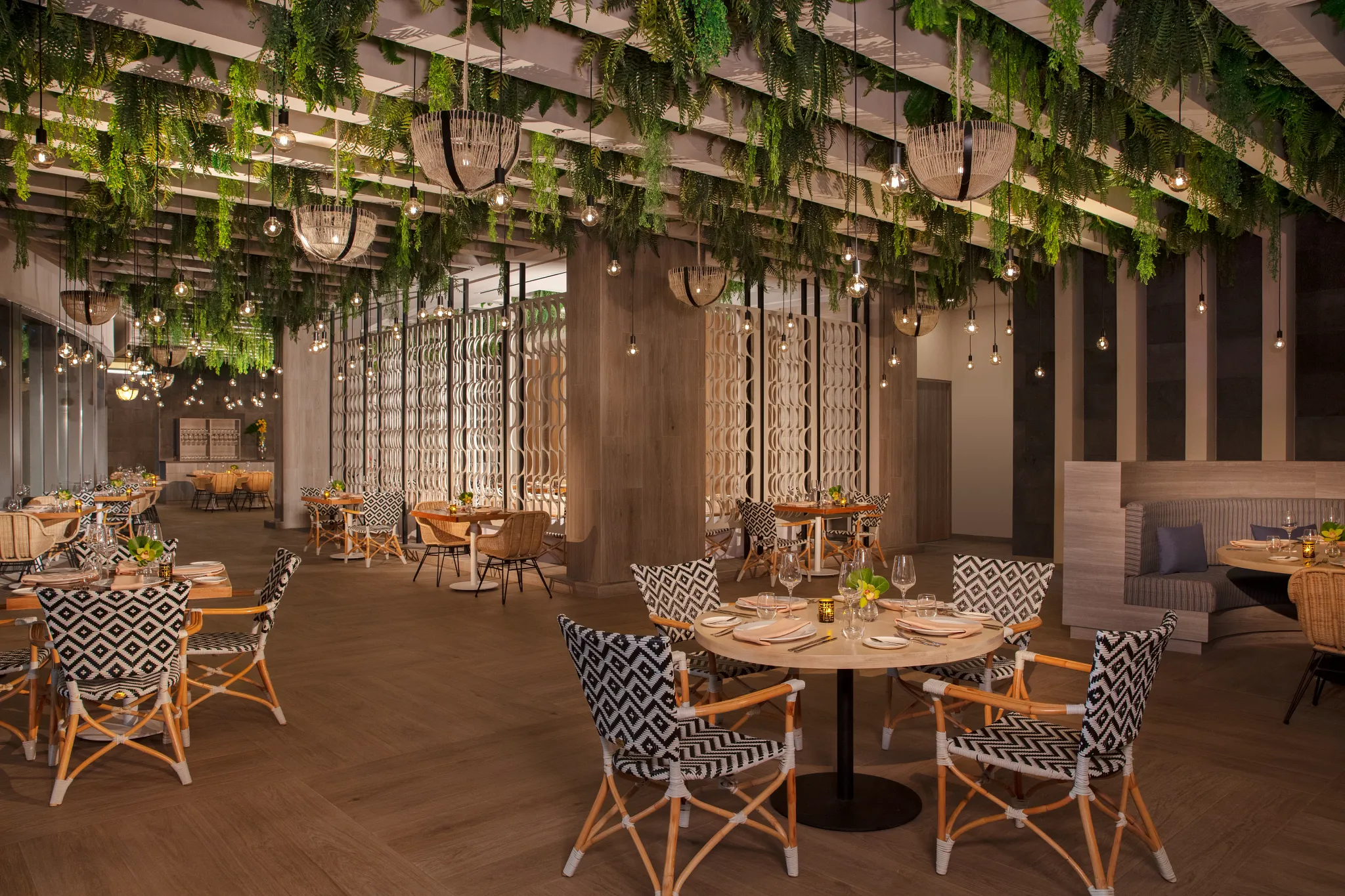 Elegant indoor dining area at Portofino restaurant inside Secrets Bahia Mita Surf & Spa Resort, featuring modern décor and upscale ambiance.