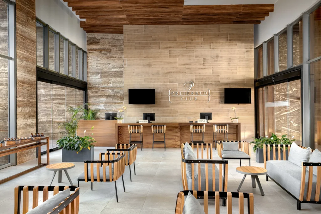 Preferred Club check-in lobby at Secrets Bahía Mita Surf & Spa Resort featuring modern wood design and exclusive guest services.