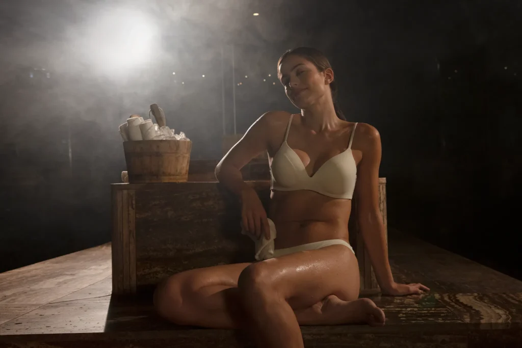 Woman relaxing in the steam room at Secrets Bahía Mita Surf & Spa Resort, enjoying a tranquil spa wellness experience.