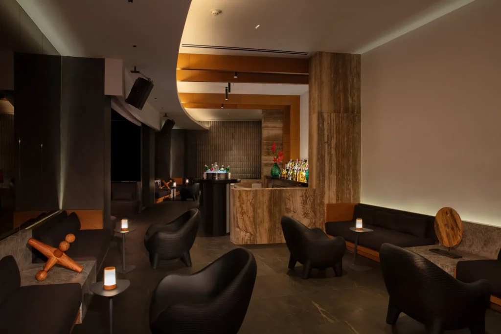 Intimate speakeasy-style bar with ambient lighting at Secrets Bahia Mita Surf & Spa Resort.