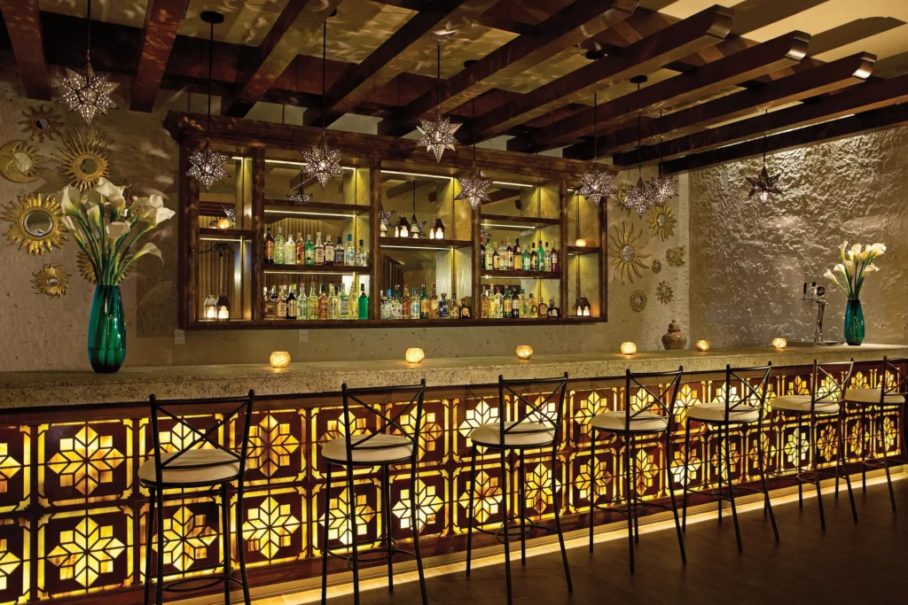 El Patio restaurant at Secrets Puerto Los Cabos featuring traditional Mexican décor, warm lighting, and authentic à la carte cuisine.