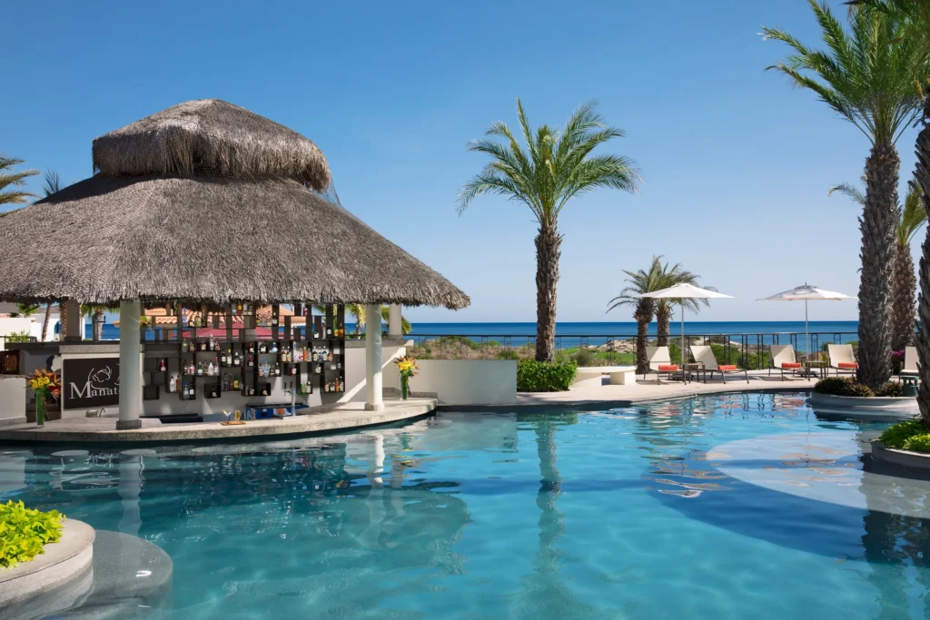 Manatees Swim-Up Bar at Secrets Puerto Los Cabos featuring a poolside bar, refreshing cocktails, and a relaxed resort atmosphere.
