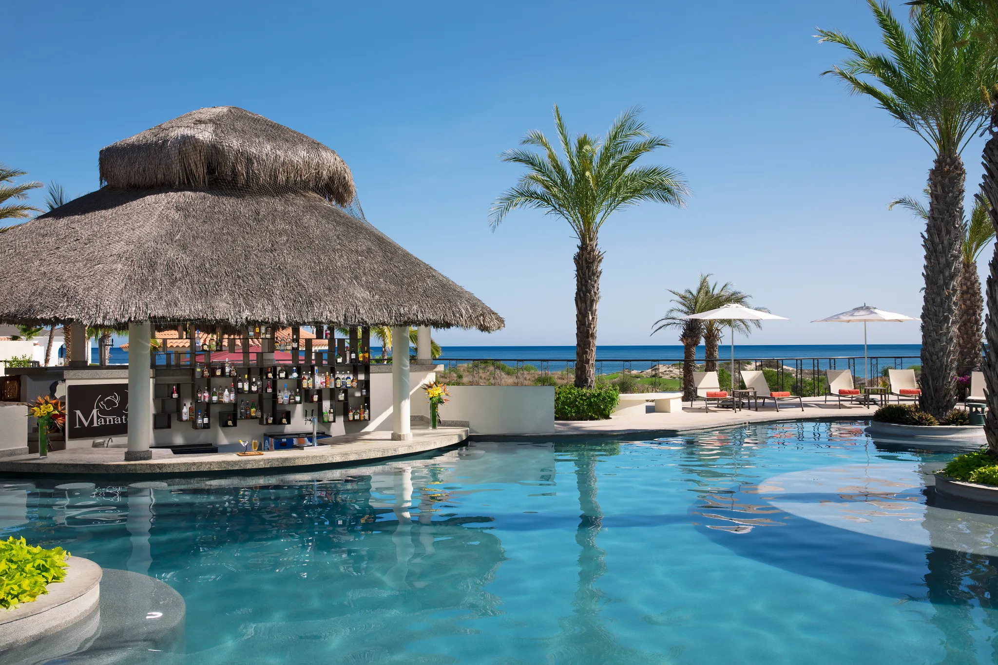 Manatees swim-up bar at Secrets Puerto Los Cabos for poolside cocktails without leaving the water