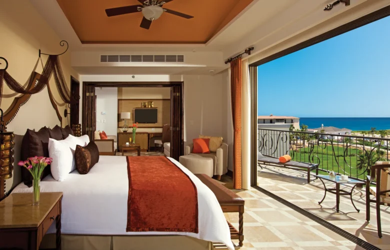 Master Suite Ocean View bedroom with king bed and balcony at Secrets Puerto Los Cabos.