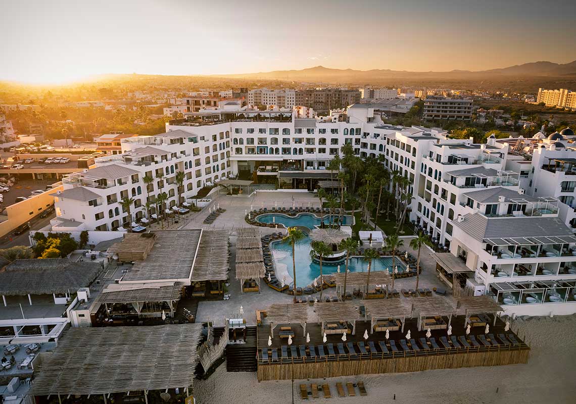 ME Cabo beachfront resort with stylish pool scene and views of El Arco in Cabo San Lucas.