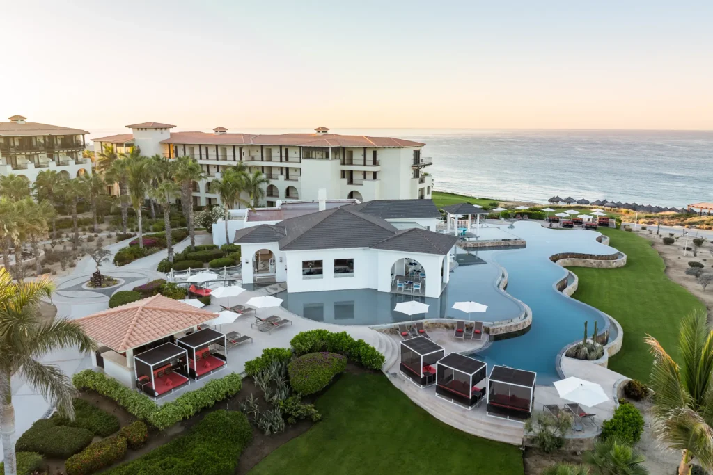 Exclusive Preferred Club pool with cabanas at Secrets Puerto Los Cabos Golf & Spa Resort overlooking the ocean.