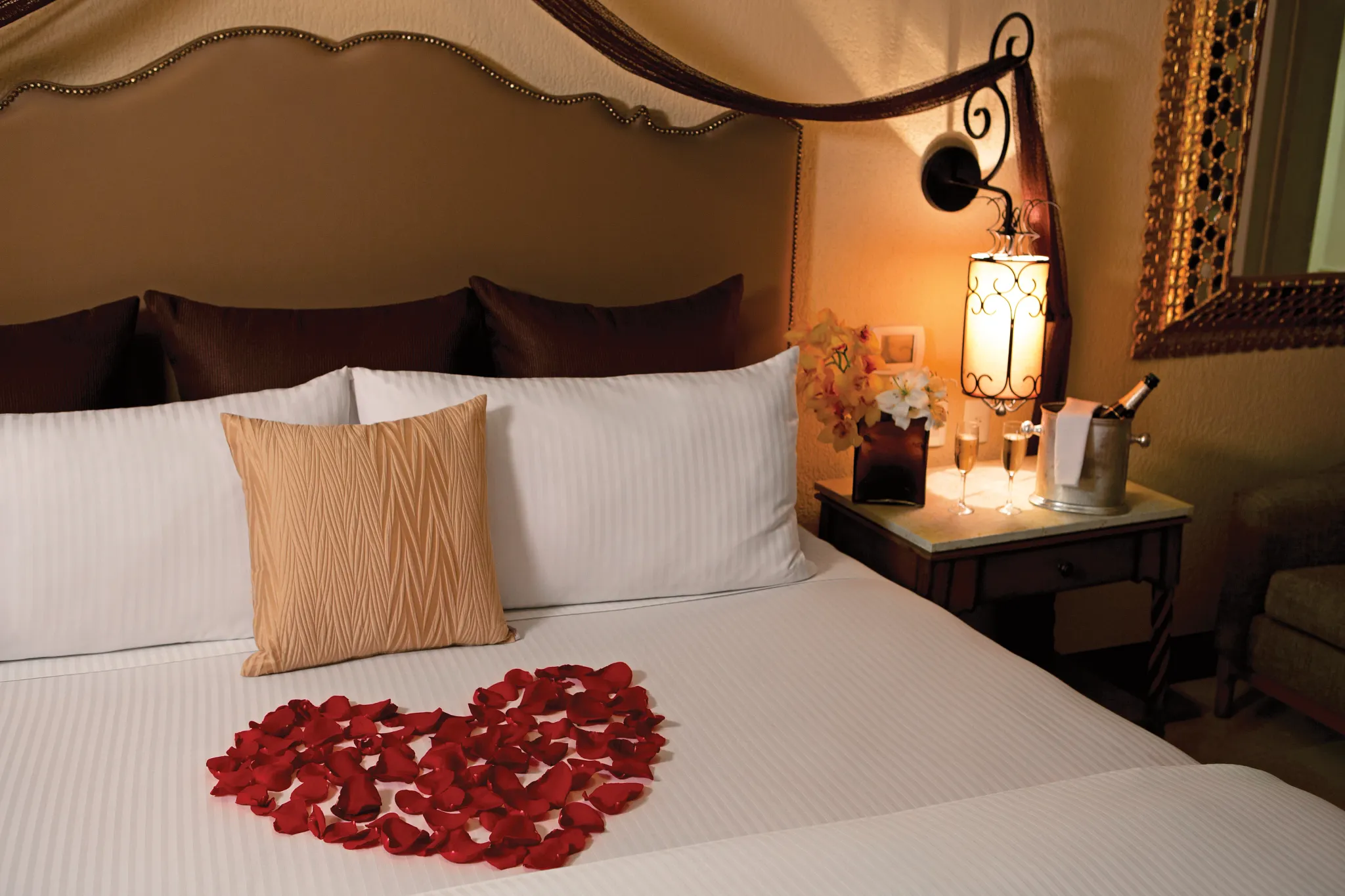 Presidential Suite Swim Out bedroom with romantic turndown and rose petals at Secrets Puerto Los Cabos Golf & Spa Resort.
