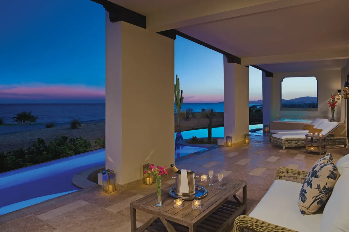 Presidential Suite Swim Out terrace at sunset with lounge seating and ocean views at Secrets Puerto Los Cabos Golf & Spa Resort.