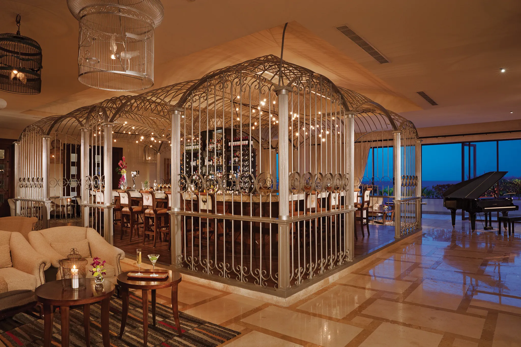 Rendezvous Lobby Bar at Secrets Puerto Los Cabos featuring chic décor, stylish seating, and handcrafted cocktails in an open-air lounge.