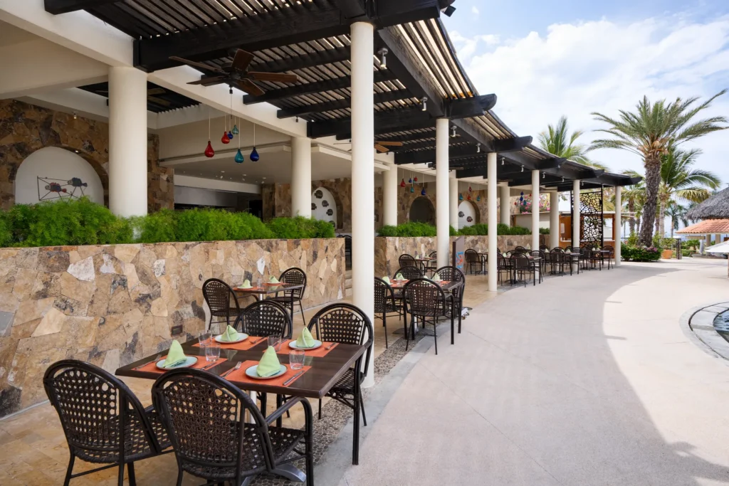 Seaside Grill at Secrets Puerto Los Cabos featuring poolside dining, ocean views, and a casual open-air grill setting.