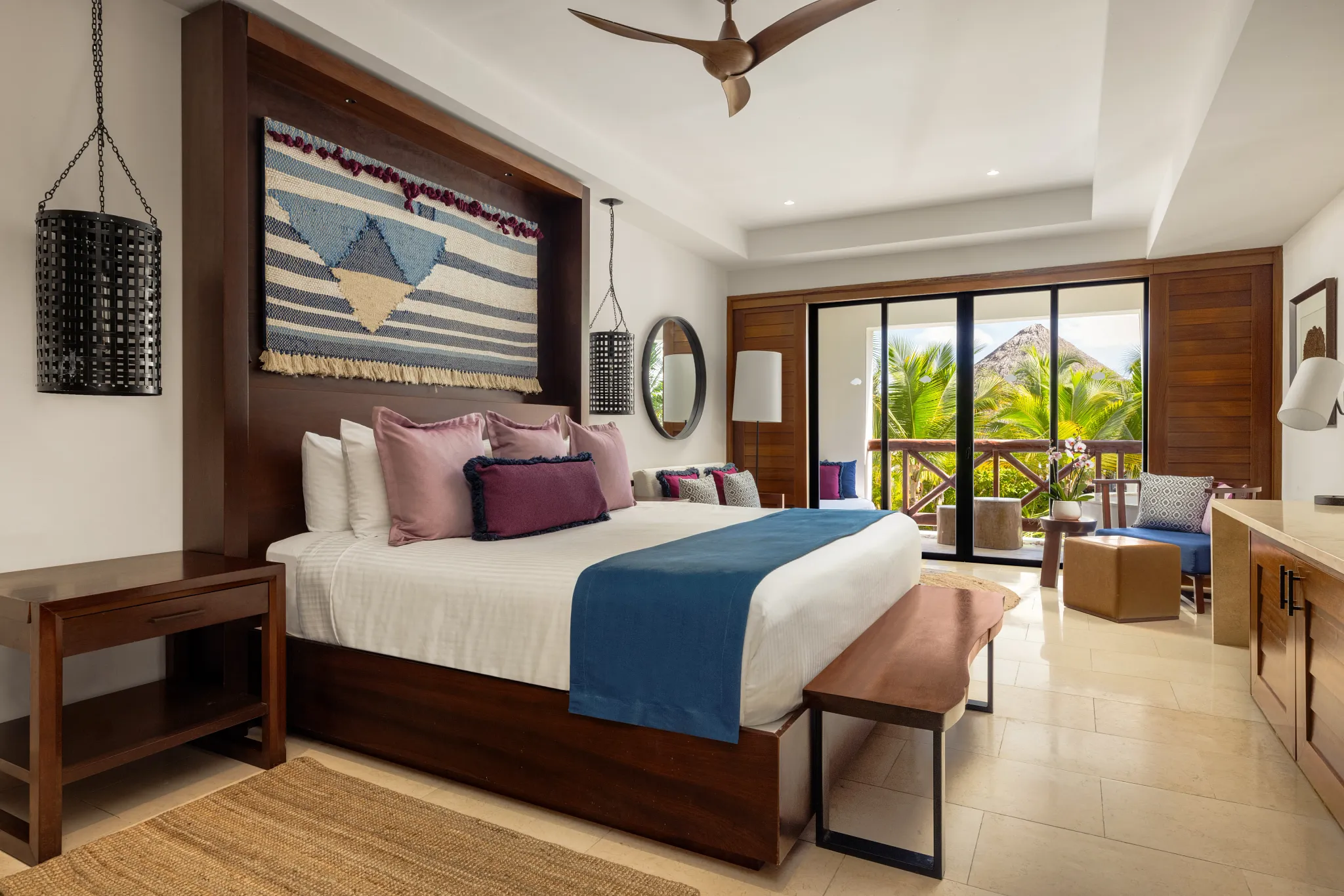 Junior Suite King Bed with private balcony and tropical resort setting at Secrets Cap Cana.