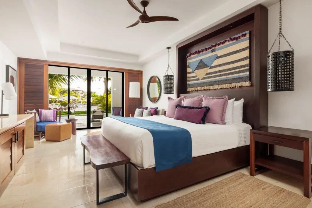 Junior Suite Swim Out with king bed and furnished terrace offering direct access to the pool at Secrets Cap Cana Resort & Spa.