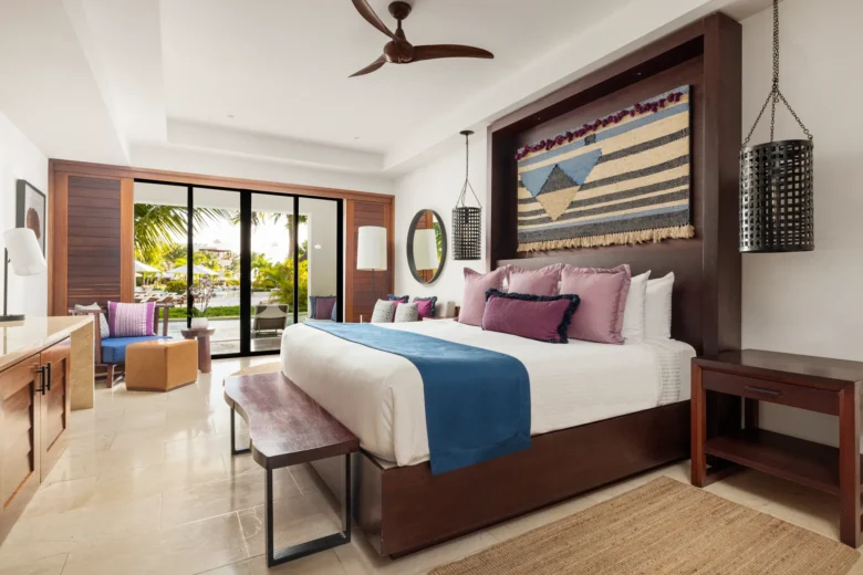 Junior Suite Swim Out with king bed and furnished terrace offering direct access to the pool at Secrets Cap Cana Resort & Spa.