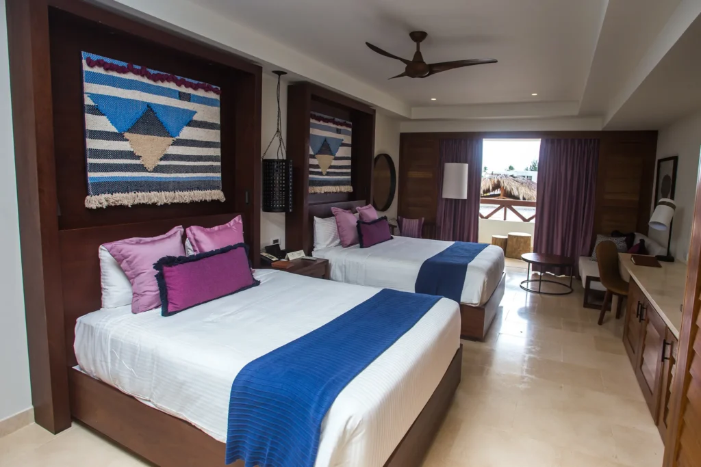 Junior Suite Tropical View with two double beds at Secrets Cap Cana Resort & Spa.