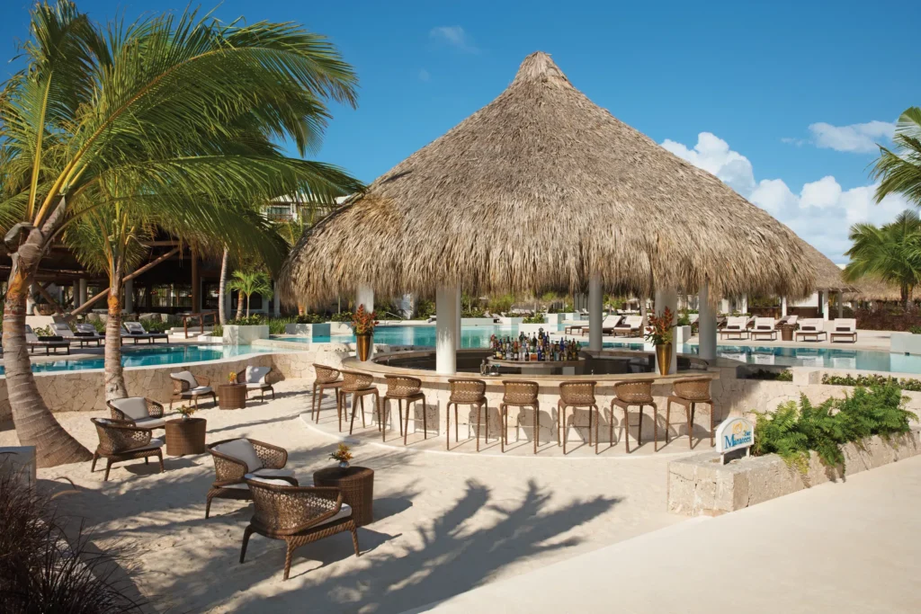 Manatees beach bar at Secrets Cap Cana Resort & Spa featuring tropical cocktails, beachfront seating, and stunning Caribbean ocean views.