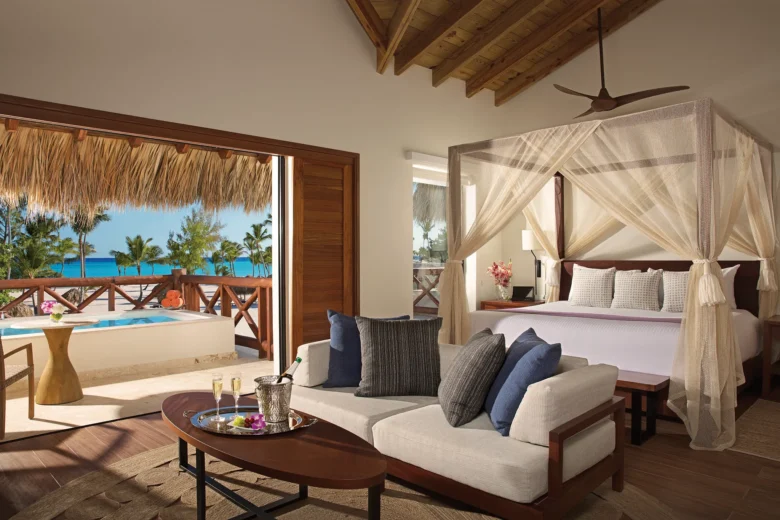 Preferred Club Bungalow Master Suite Ocean Front bedroom with king-size canopy bed, sitting area, plunge pool, and oceanfront balcony views.