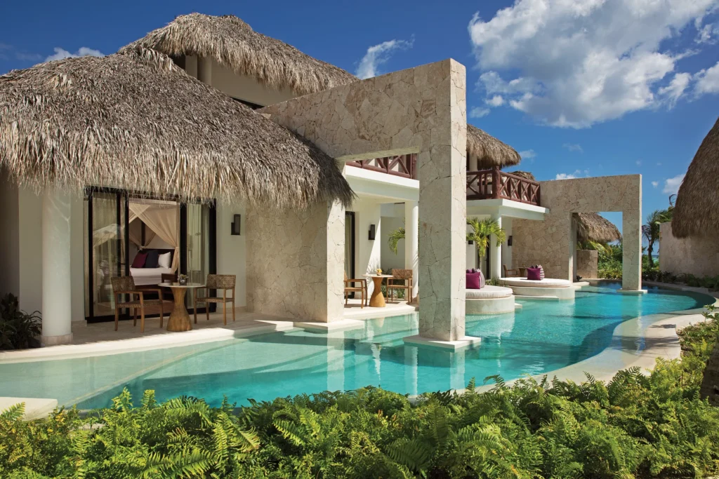 Preferred Club Bungalow Suite Swim Out Ocean Front exterior featuring luxury Caribbean-style bungalows with thatched roofs and direct swim-out pool access.