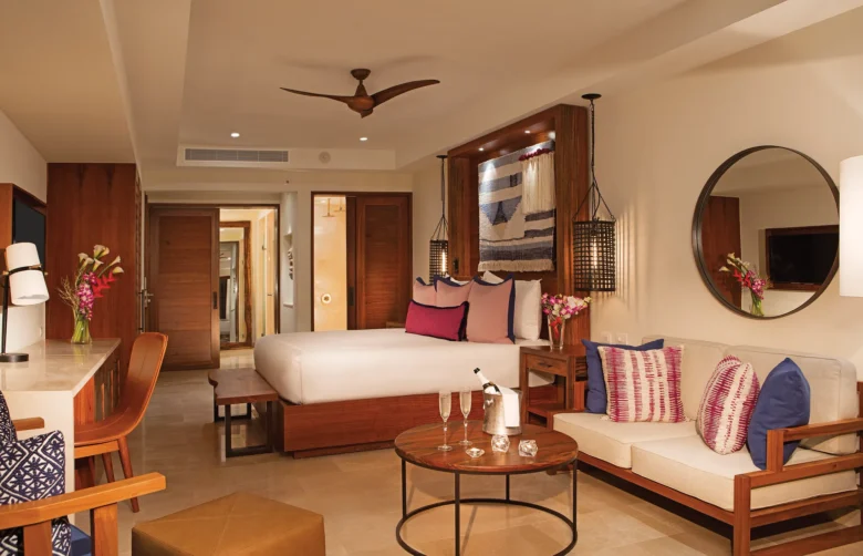 Preferred Club Junior Suite Ocean View with king-size bed, sitting area, and contemporary Caribbean-inspired décor at Secrets Cap Cana Resort & Spa.