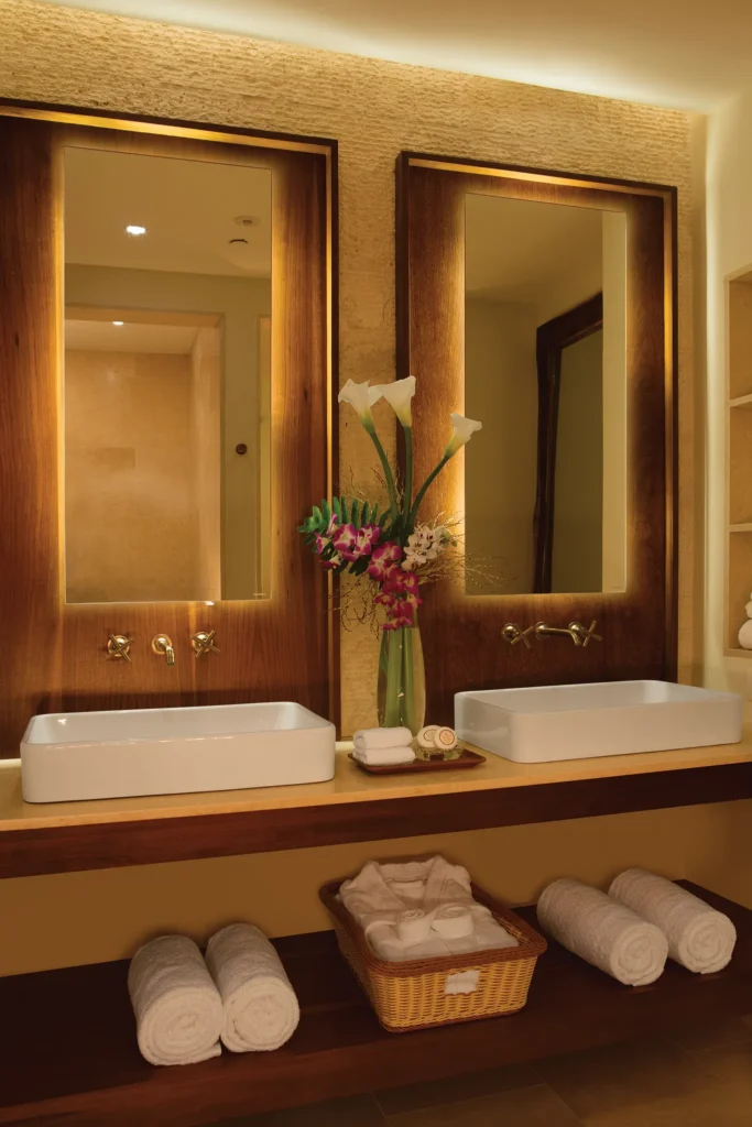 Preferred Club Junior Suite Swim Out Pool View bathroom with dual vanities, illuminated mirrors, and luxury spa-style finishes at Secrets Cap Cana Resort & Spa.