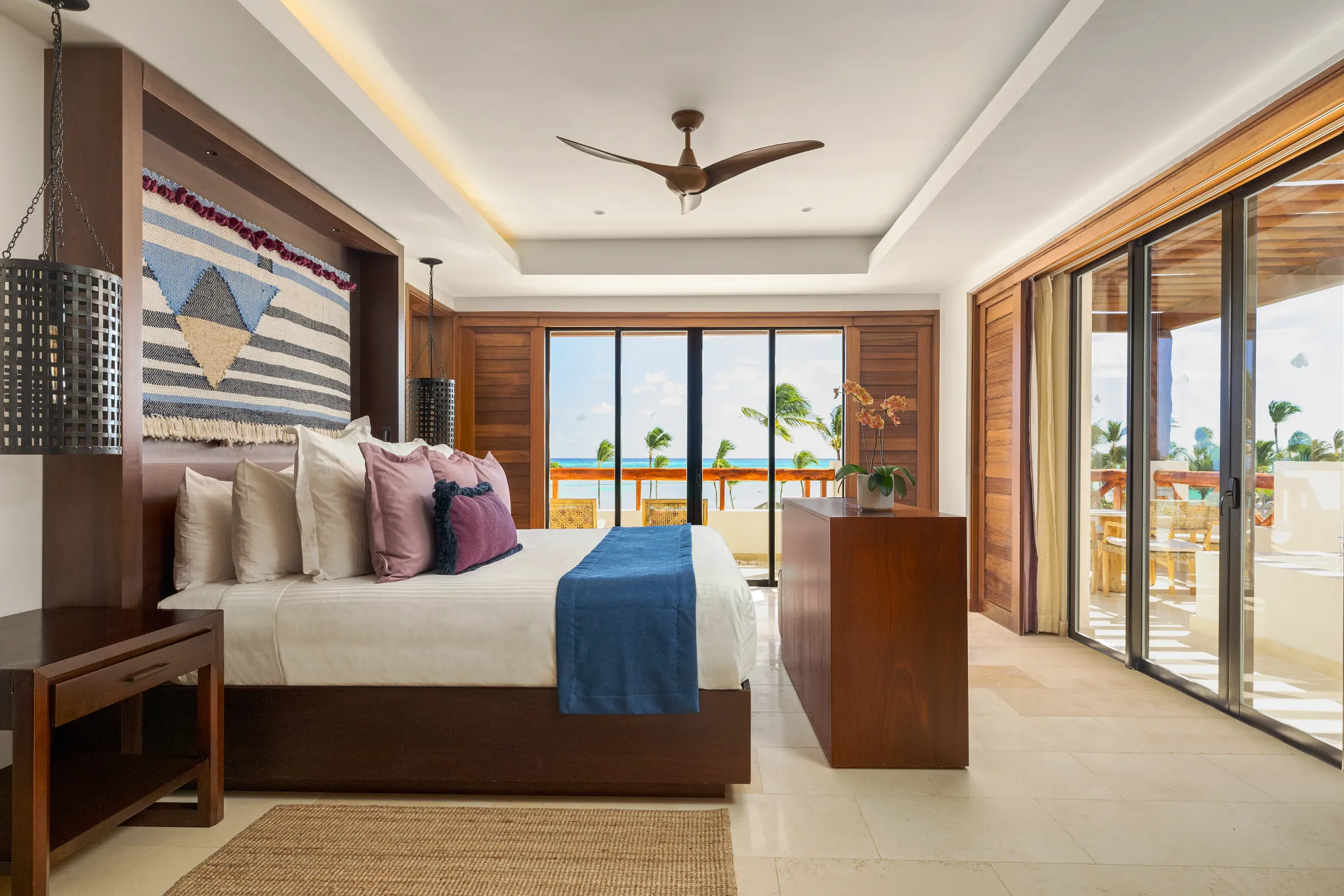 Preferred Club Presidential Suite bedroom with king bed and oceanfront balcony at Secrets Cap Cana Resort & Spa.