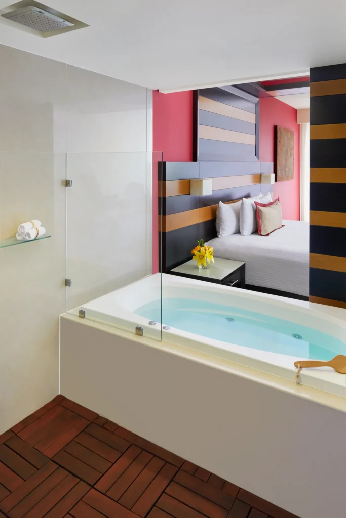 Junior Suite bathroom with indoor hot tub and rain shower at Secrets Huatulco Resort & Spa.
