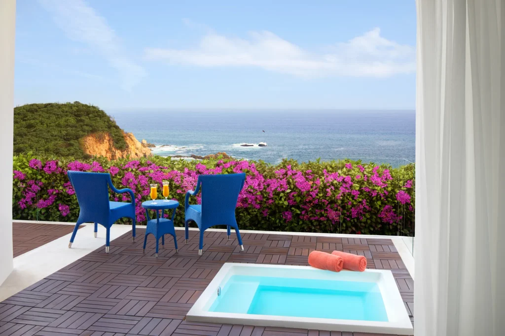Private balcony with hot tub and ocean view at Secrets Huatulco Junior Suite.