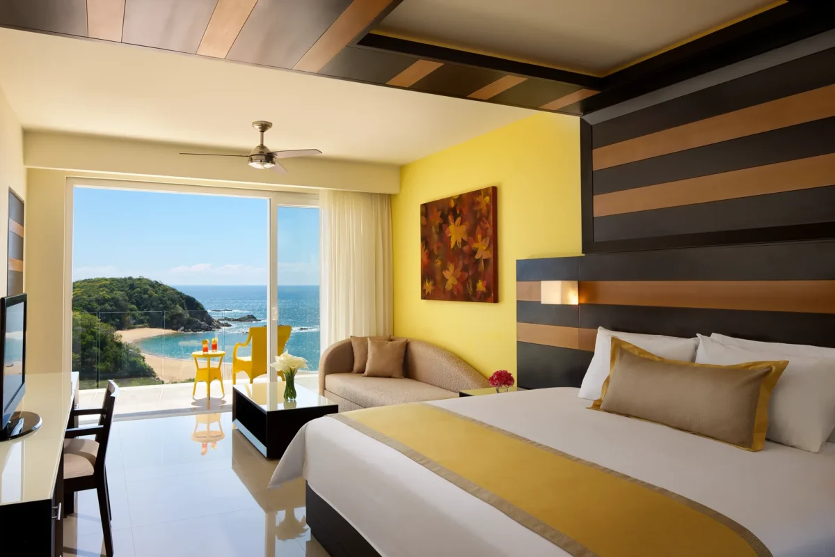 Junior Suite Ocean Front with king-size bed and private balcony at Secrets Huatulco Resort & Spa with ocean views.