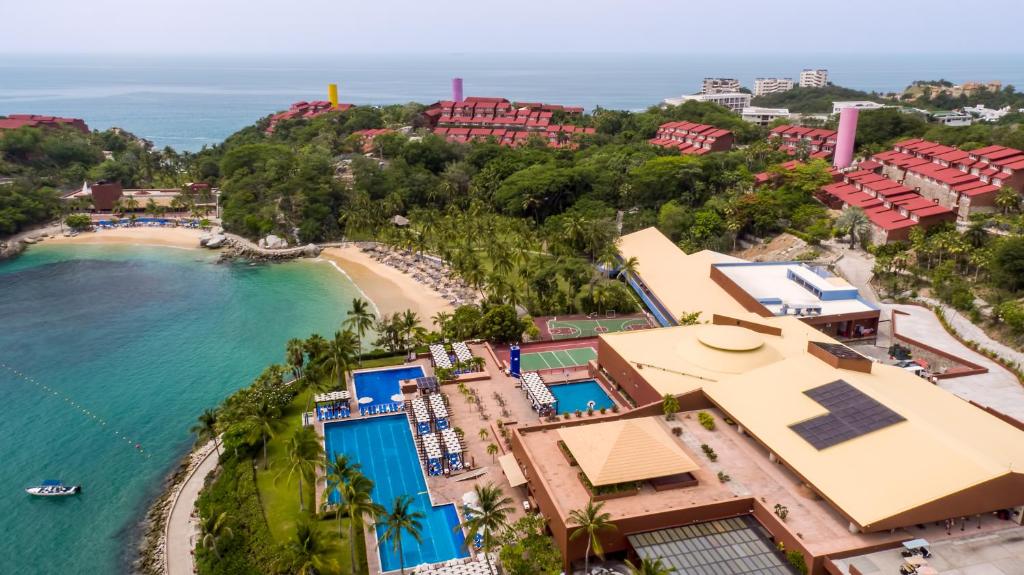 Las Brisas Huatulco all-inclusive resort with terraced hillside architecture, multiple pools, and Tangolunda Bay views in Oaxaca, Mexico.