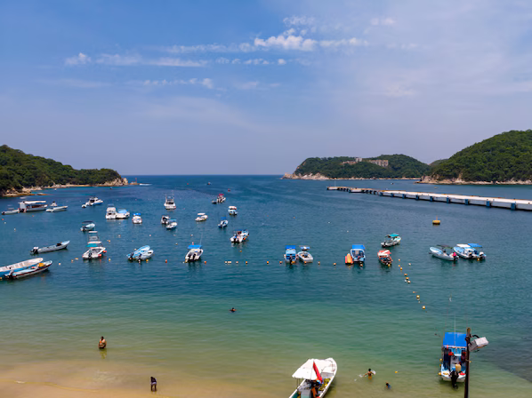 Playa Santa Cruz near Secrets Huatulco Resort & Spa with vibrant harbor views and sandy beach in Huatulco