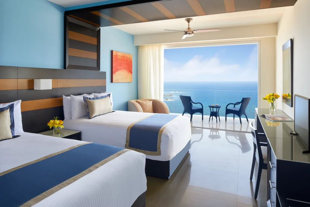 Preferred Club Junior Suite Ocean Front with two double beds at Secrets Huatulco Resort & Spa.