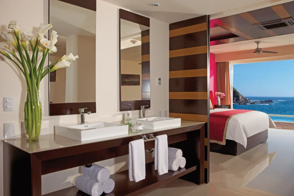 Preferred Club Junior Suite Swim Out bathroom with double sinks and modern vanity at Secrets Huatulco Resort & Spa.