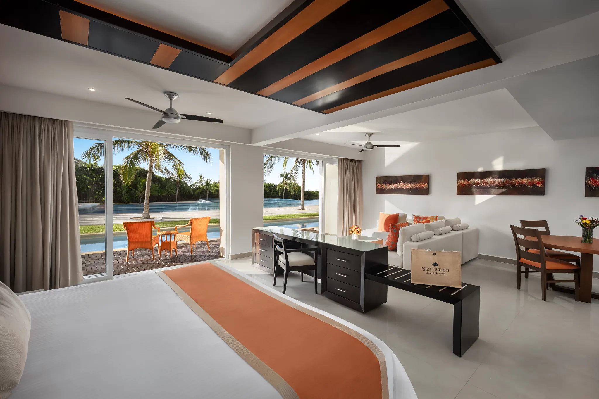 Preferred Club One-Bedroom Swim Out living area at Secrets Huatulco with separate sitting space, elegant furnishings, and swim-out pool access on the Oaxacan coast.