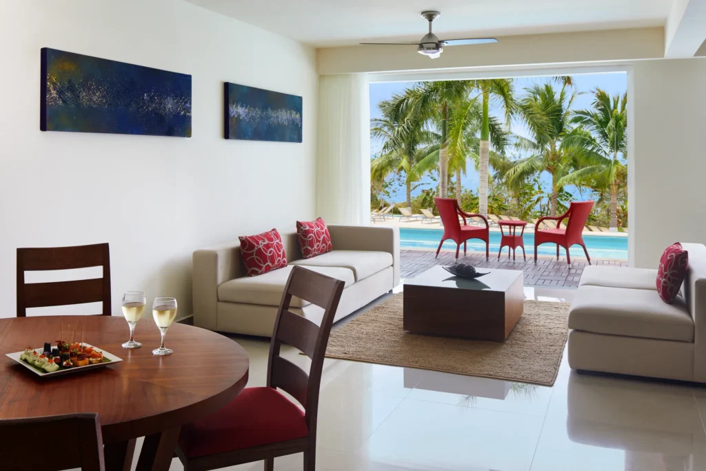 Preferred Club One-Bedroom Swim Out suite with living room and dining area at Secrets Huatulco Resort & Spa.