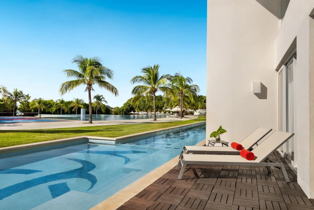 Preferred Club Two-Level Presidential Suite Swim Out terrace with loungers and direct pool access at Secrets Huatulco.