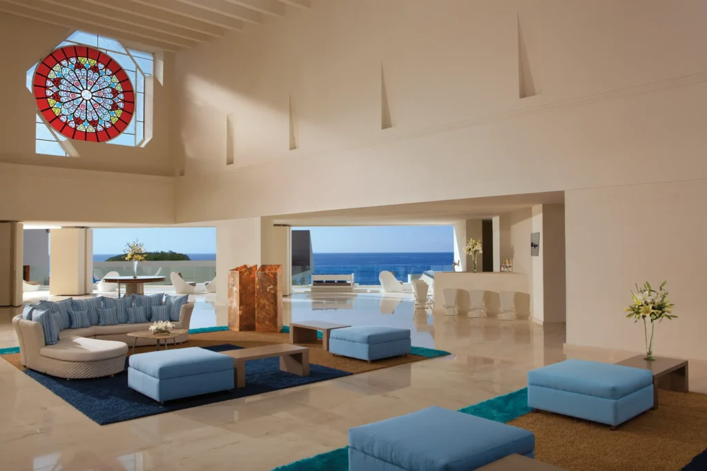 Elegant open-air lobby with ocean views at Secrets Huatulco Resort & Spa in Mexico.