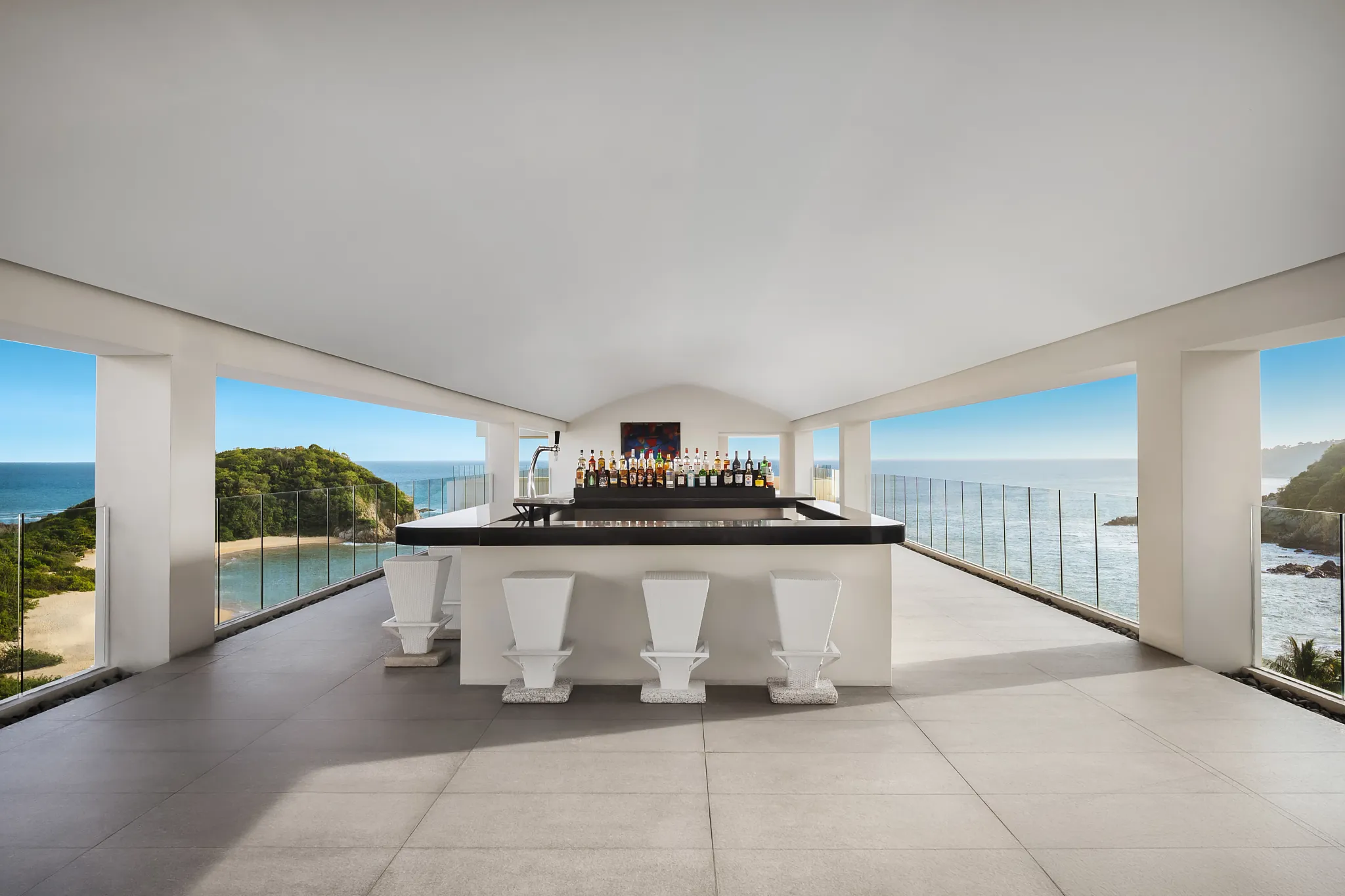 Sky Bar rooftop lounge at Secrets Huatulco with panoramic views of Tangolunda Bay for sunset cocktails