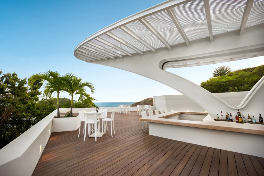 Sugar Reef poolside bar at Secrets Huatulco Resort & Spa featuring modern open-air design, tropical cocktails, and ocean-view terrace seating.