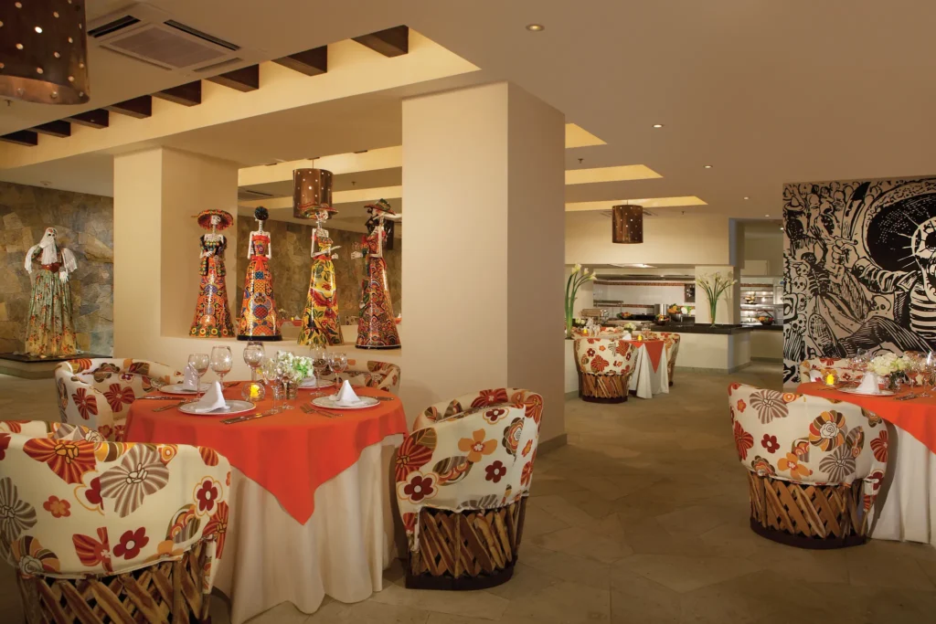 Tamarindo Mexican restaurant at Secrets Huatulco Resort & Spa featuring colorful décor, traditional Mexican art, and festive table settings.
