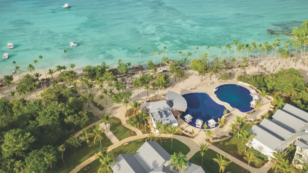 Aerial view of beachfront pools and turquoise Caribbean waters at Secrets La Romana Resort & Spa.