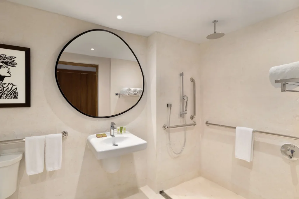 Accessible bathroom with walk-in rain shower at the Deluxe Garden View room at Secrets La Romana Resort & Spa.
