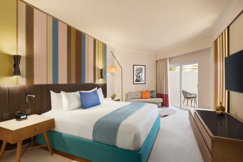 Deluxe Garden View Accessible king room with private terrace at Secrets La Romana Resort & Spa.