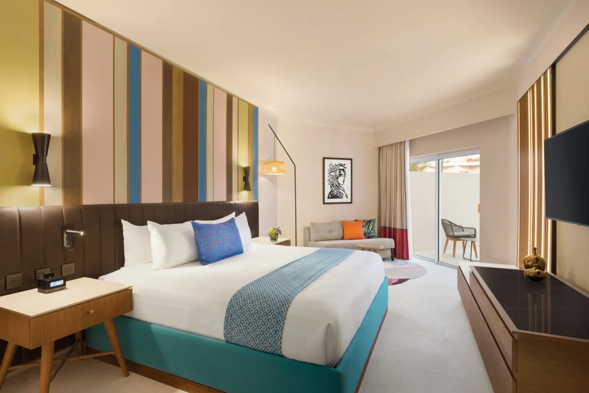 Deluxe Garden View king room with modern décor and private terrace at Secrets La Romana Resort & Spa.